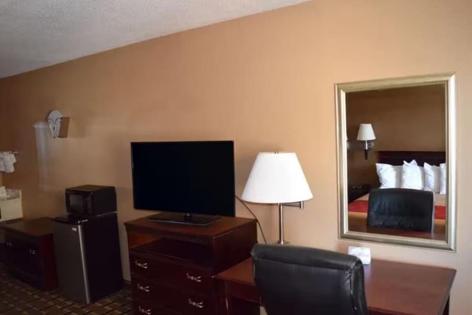 Kick back with in-room TV, fridge, and easy workspace.