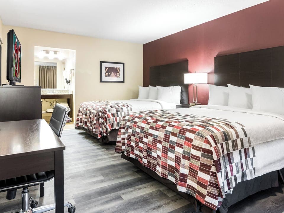 Stretch out comfortably with roomy layout and cozy bedside lighting.