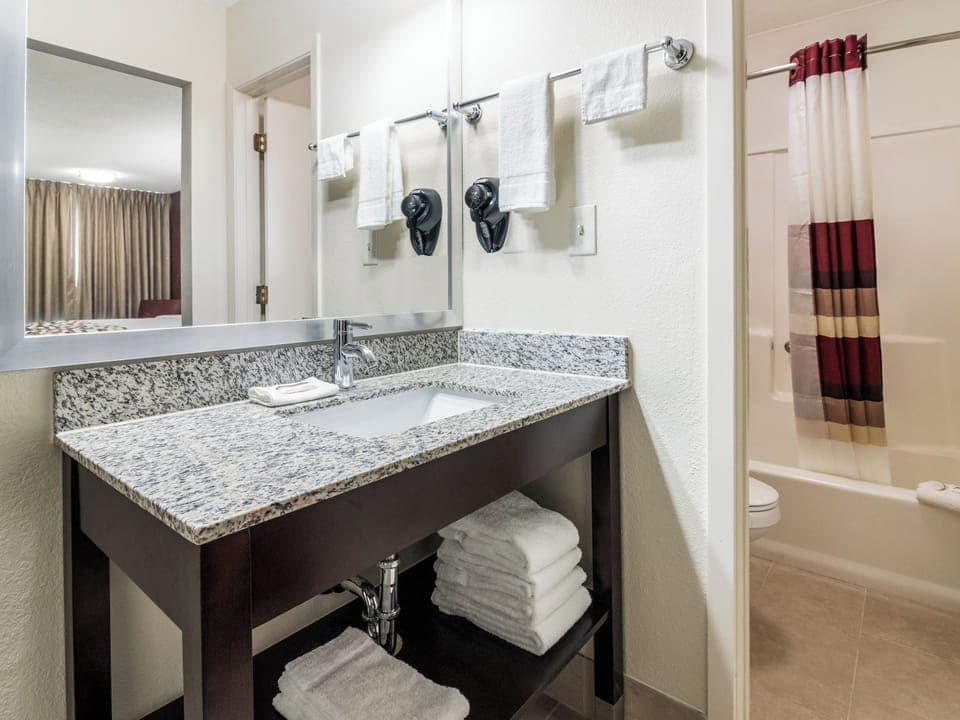 Refresh at the granite vanity, then rinse off in comfort.