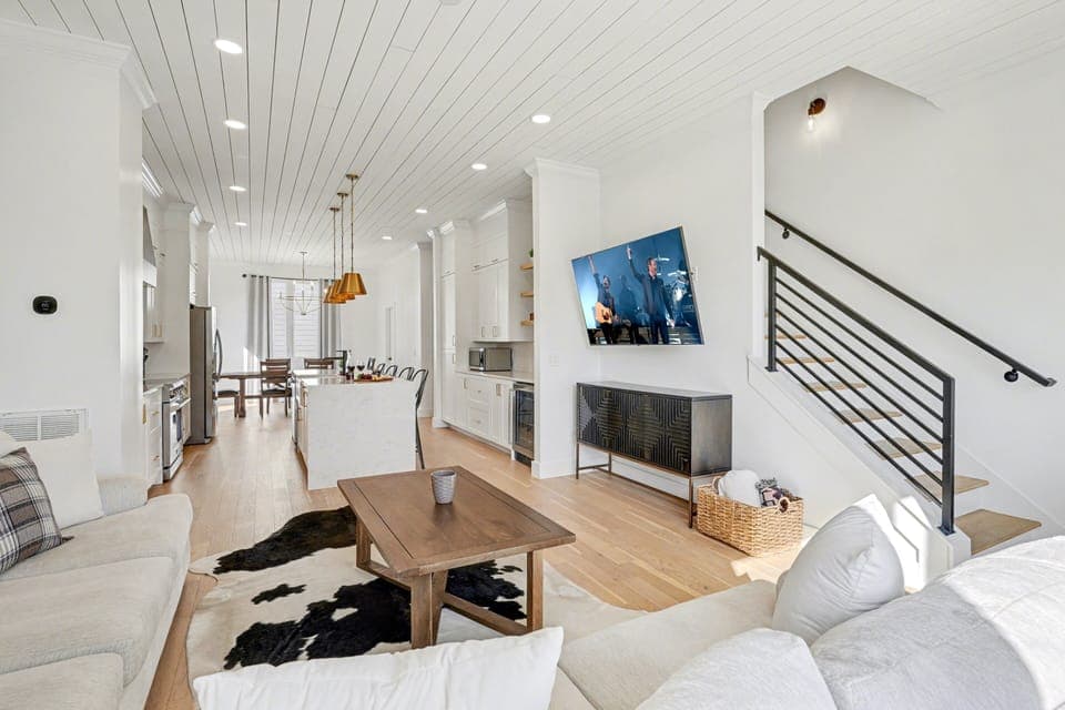 2nd Floor: Bright and open living area with cozy furnishings, a smart TV, and a private balcony.
