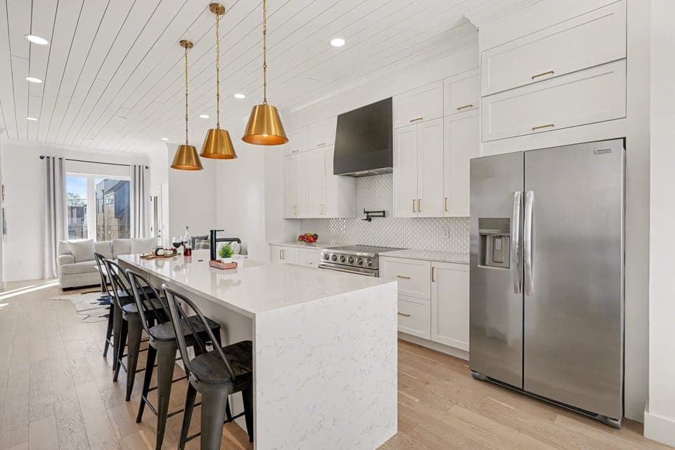 2nd Floor: Fully equipped kitchen with stainless steel appliances, a kitchen island with seating for 4 guests, wine cooler, and amble counter space.