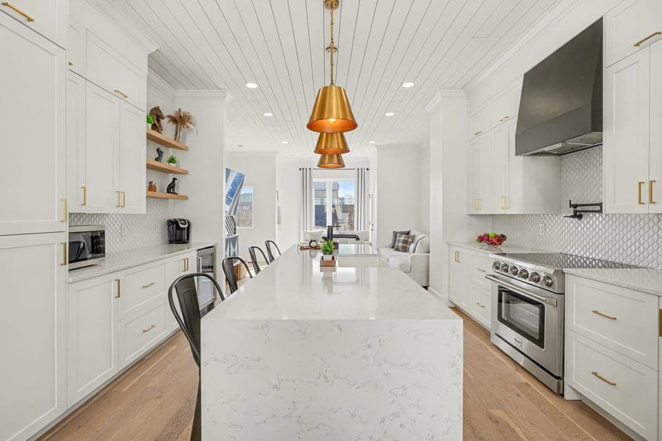 2nd Floor: Fully equipped kitchen with stainless steel appliances, a kitchen island with seating for 4 guests, wine cooler, and amble counter space.