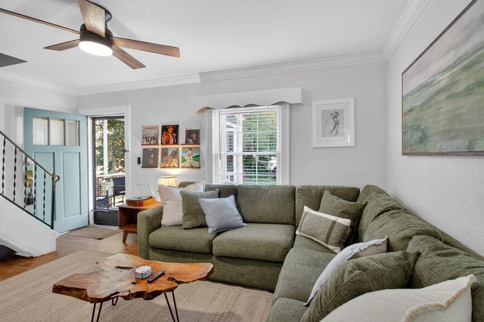 Bright living room with comfortable seating and natural light, just inside the front entrance.