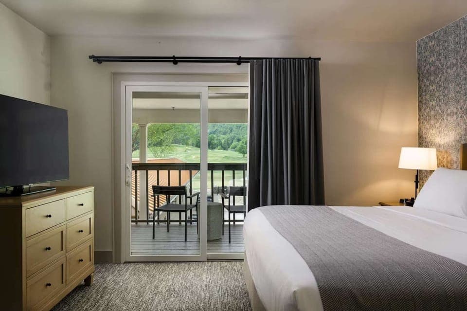 King room with balcony seating and golf course view