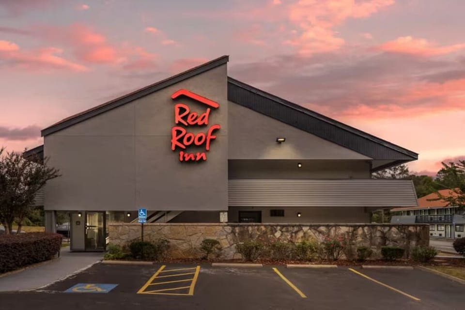 Arrive to a warm welcome beneath glowing sunset signage.
