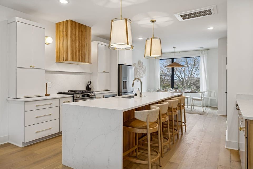 Kitchen: Sleek lines, warm tones, and high-end touches — the perfect kitchen for cooking, entertaining, and enjoying life together.