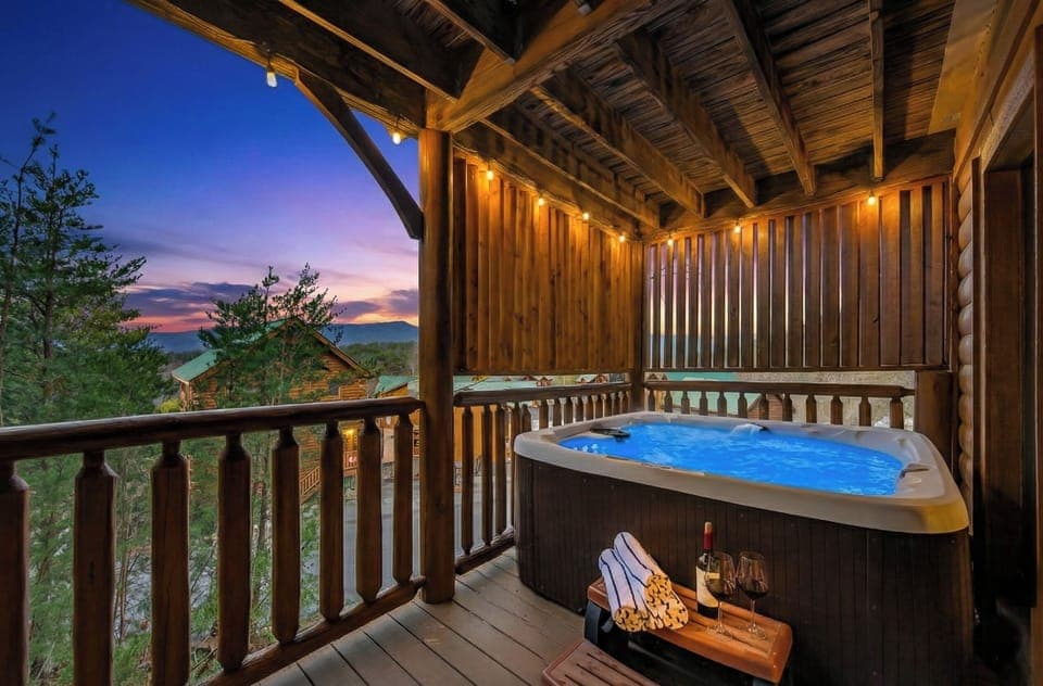 Your evening starts here — covered hot tub, Smoky Mountain sunset, and nowhere else you need to be. Pool towels provided for every guest.