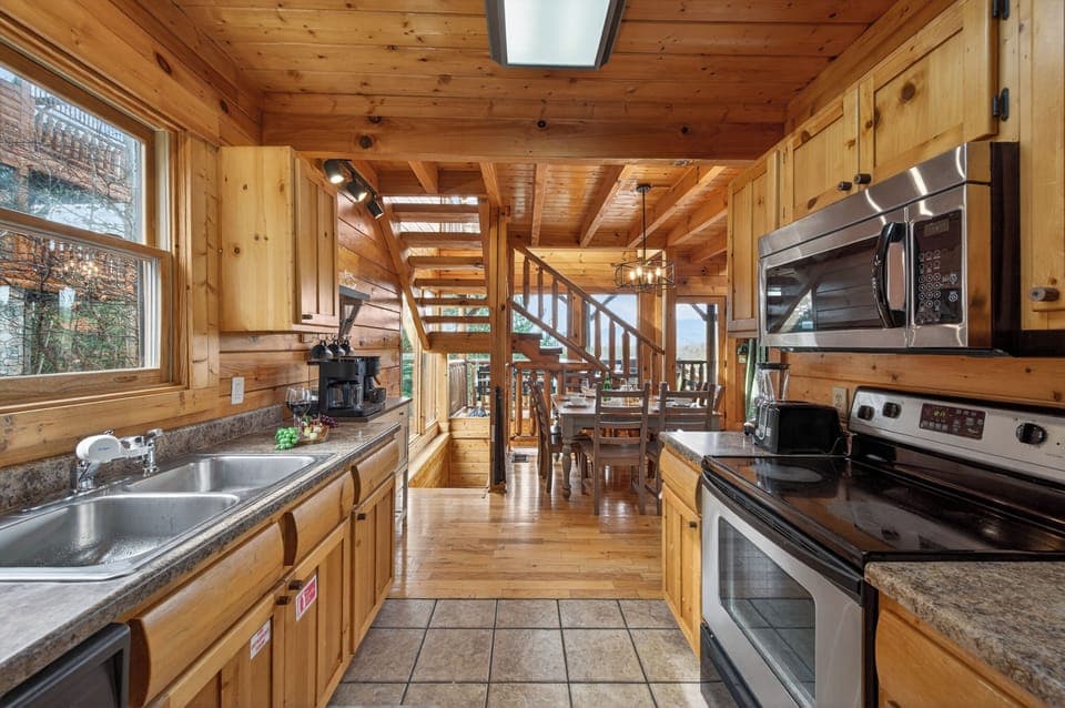 Fully equipped kitchen with everything you need to cook for the whole group — opens directly to the dining area and main level deck.