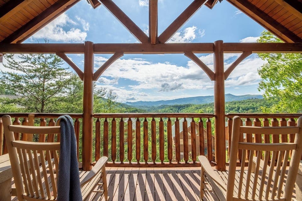 Your view from The Overlook — Smoky Mountain ridgelines, fresh mountain air, and a rocking chair with your name on it. This is what you came for.