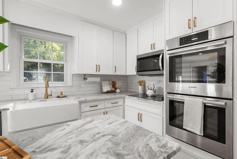 Spacious cooking area with modern appliances and bright natural light.