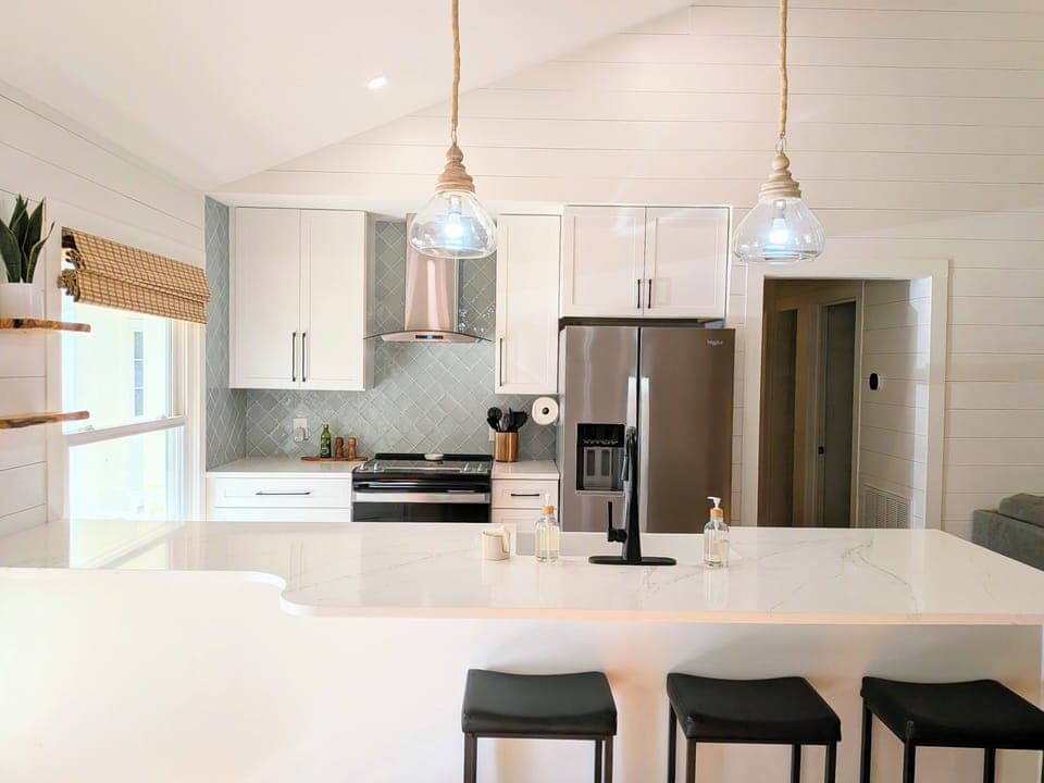 Step into a kitchen where modern minimalism meets lakeside warmth. 