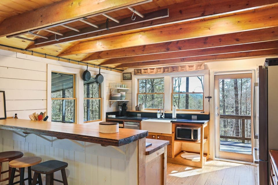 Morning sunlight filters through the trees, warming the kitchen as you prep breakfast barefoot on pine floors. The coffee brews, birds call just beyond the window, and a fresh stillness settles in. Here, even simple routines feel sacred—nourishing body, soul, and your sense of pace.