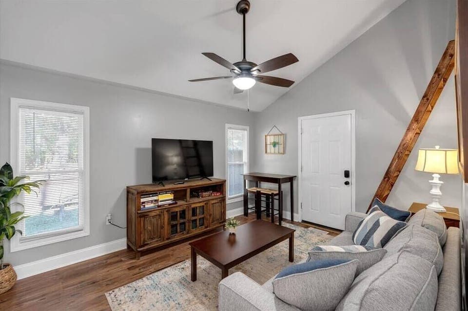 Living room with queen size sleeper sofa, TV with Netflix, small table for eating/computer work

(Notice the ladder to get up to the queen bedroom loft area)