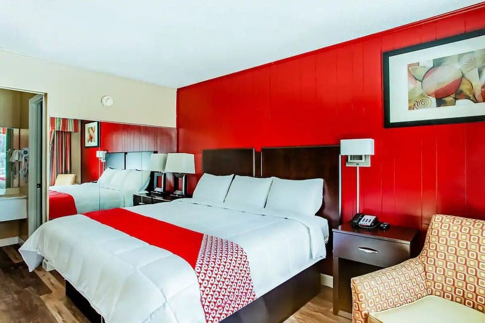 Unwind in crisp linens with bold, modern red accents.