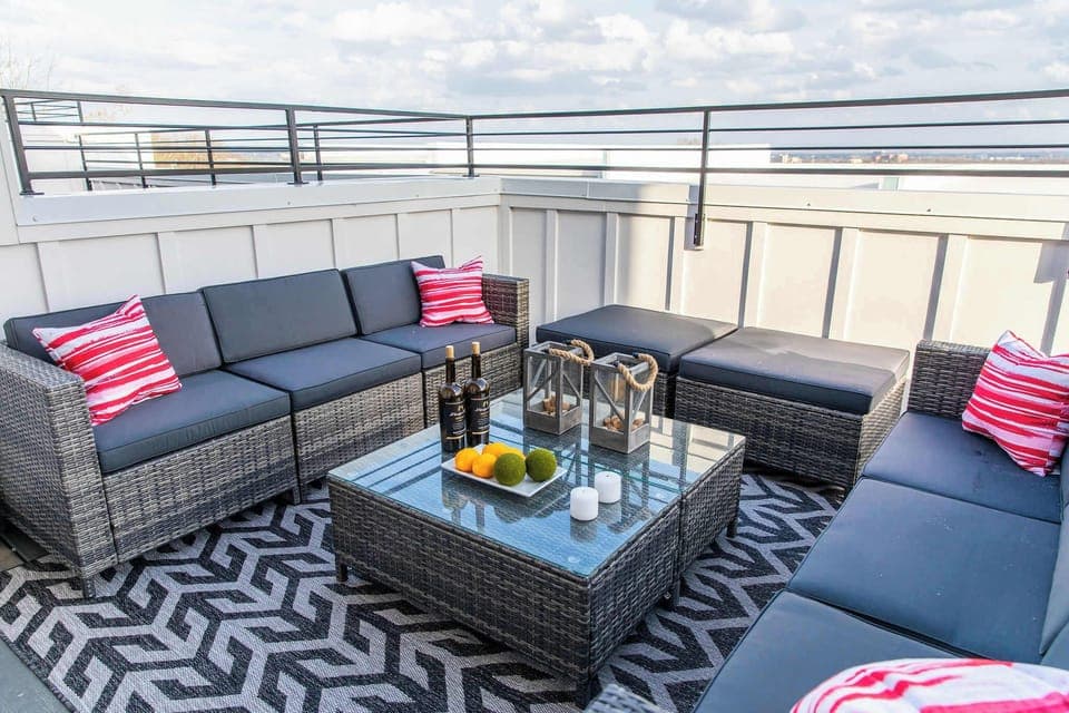 Hot tub, seating, and skyline views make this rooftop perfect for relaxation.