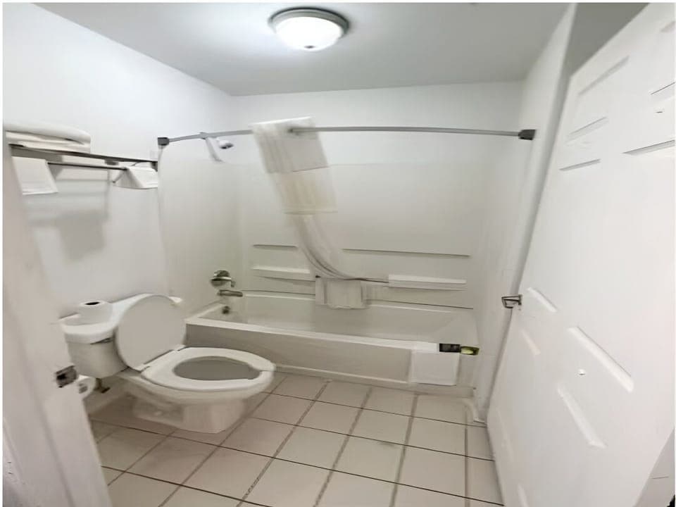 Unwind with a warm bath in this clean, bright bathroom.