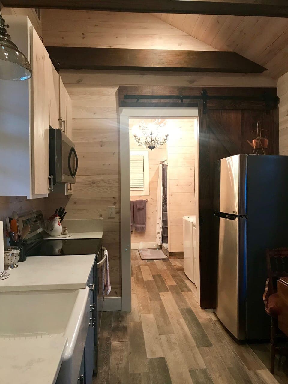 Kitchen with dining table, stove, oven, microwave, and refrigerator.