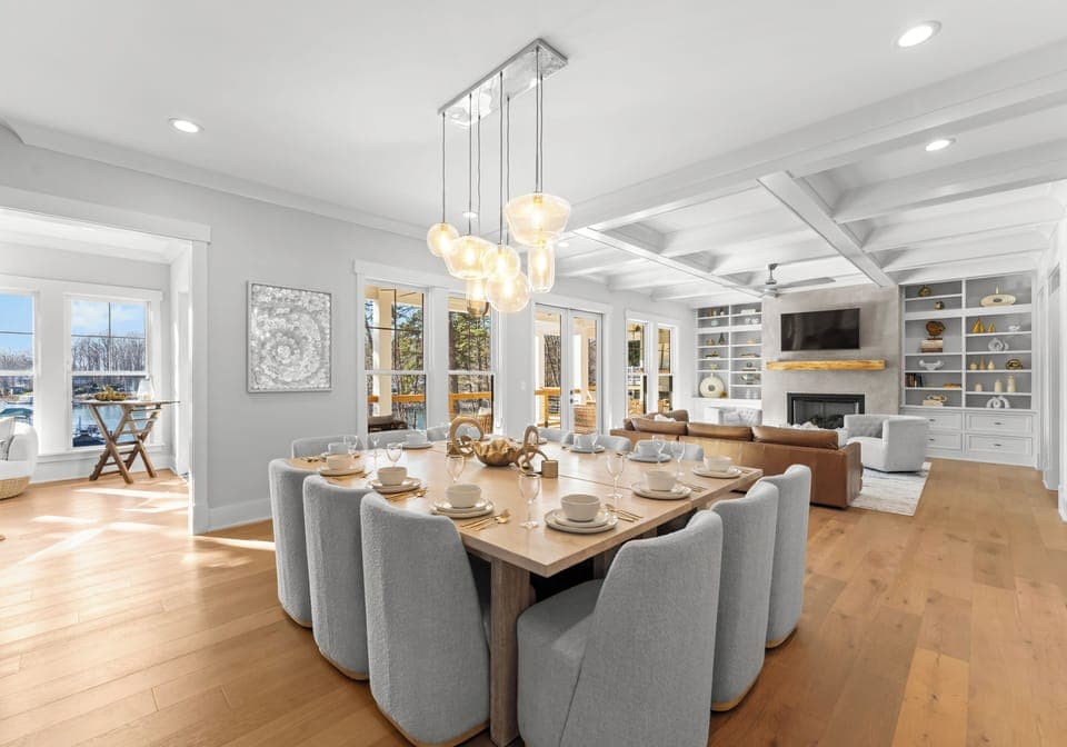 Open-concept dining and living room with access to the balcony and sunroom.