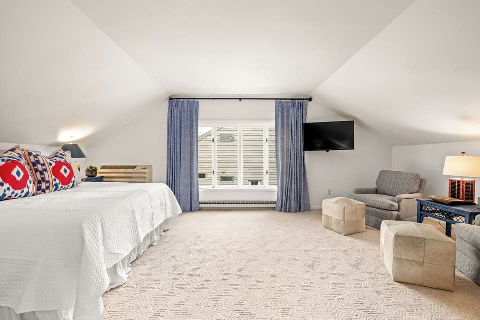 Large bedroom with seating area and Tv