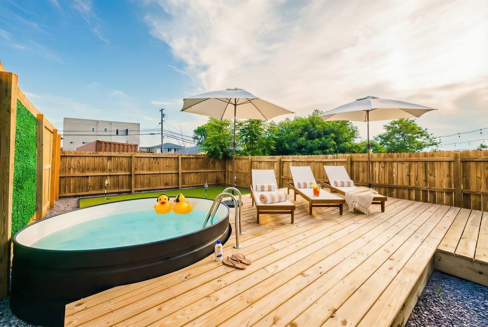 Imagine basking in the sun at this chic outdoor oasis with a hot tub and cozy lounge chairs. Ideal for a bachelorette party or family reunion, this Nashville getaway offers luxury and proximity to downtown attractions. Your upscale retreat awaits!