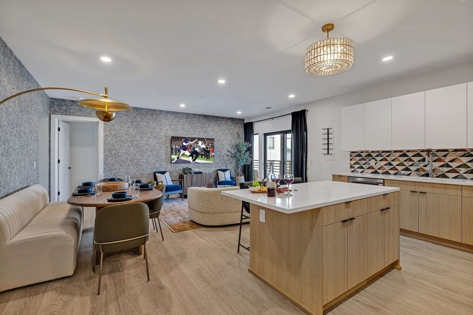 Unit 1: The fully equipped modern kitchen features culinary essentials, stainless steel appliances, and island bar seating.