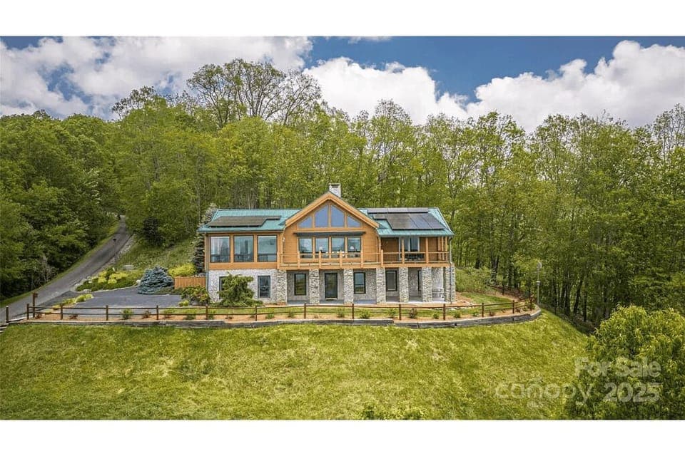 Exterior Escape: Experience mountain serenity in this stunning cabin with expansive decks and lush views!
