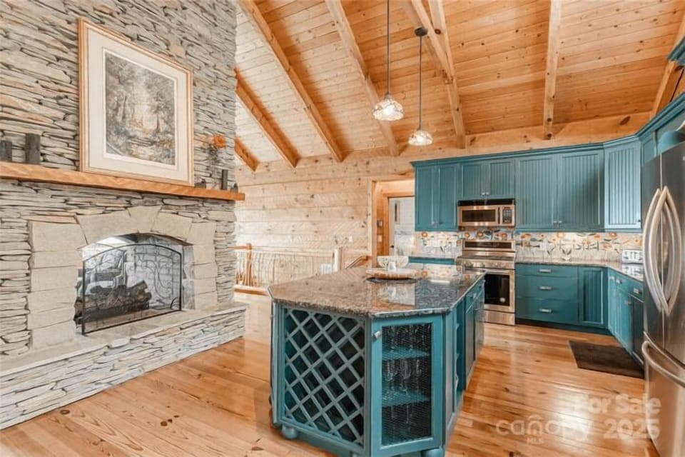 Chef's Paradise: Stunning kitchen with elegant granite, natural wood, and a charming stone fireplace!