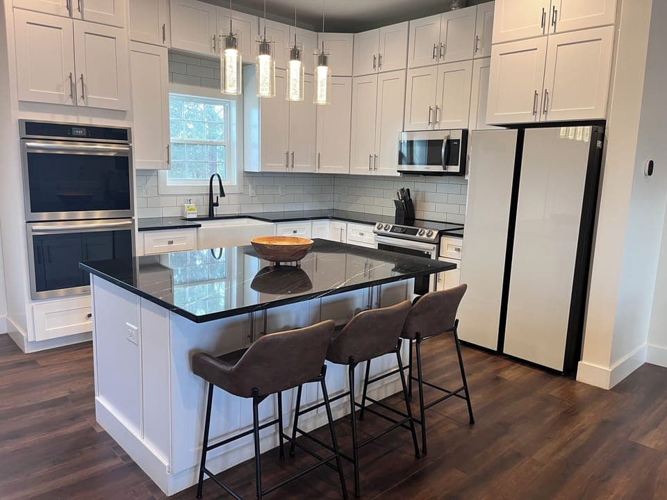 Modern kitchen with stainless appliances a large island with bar seating