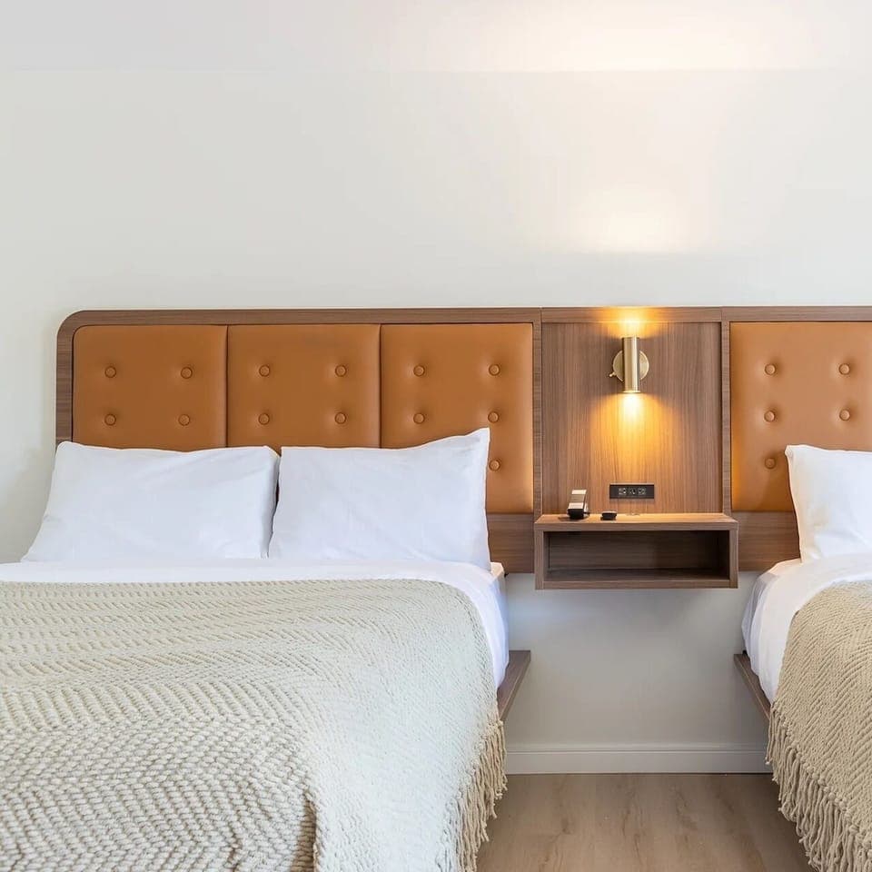 Unwind together in a bright double-bed layout with plush throws.