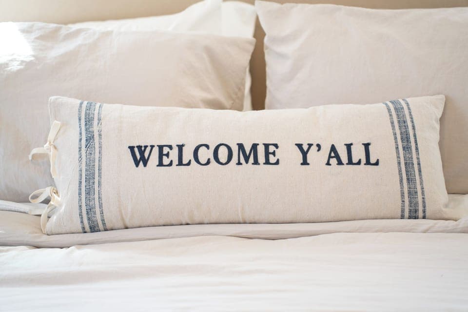 A thoughtful "Welcome Y'all" pillow on the primary king bed to help you feel at home the moment you arrive.