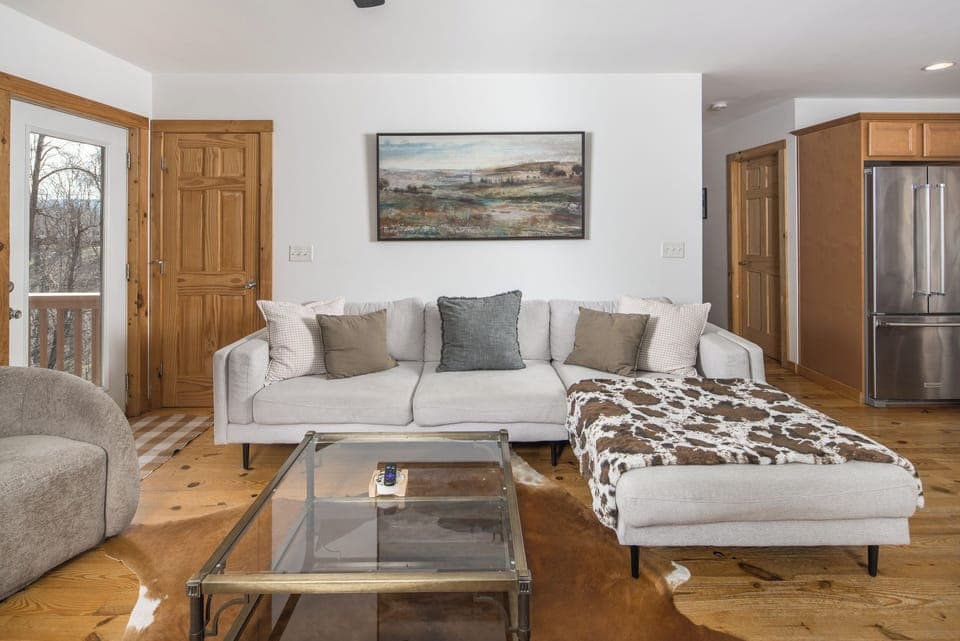 An open layout that allows the group to stay connected between the sofa and the stove.