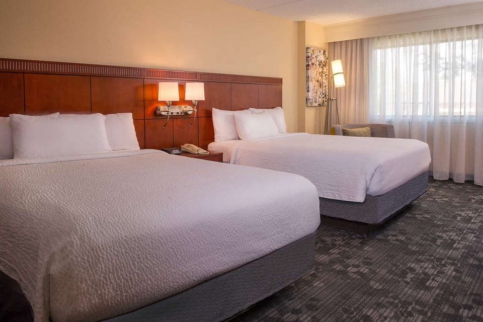 Settle into a calm double-queen space with warm lighting.
