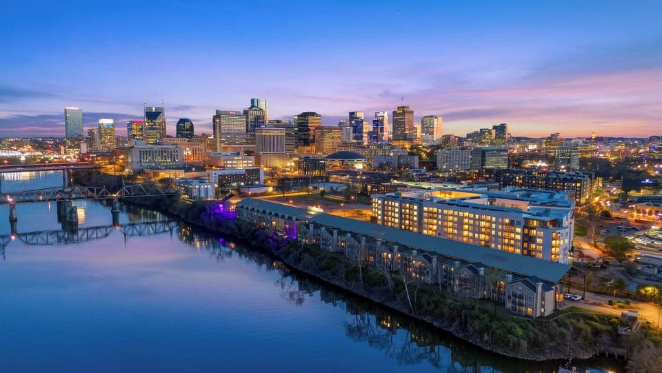 A stunning wide-angle shot of the entire riverfront and city lights.
