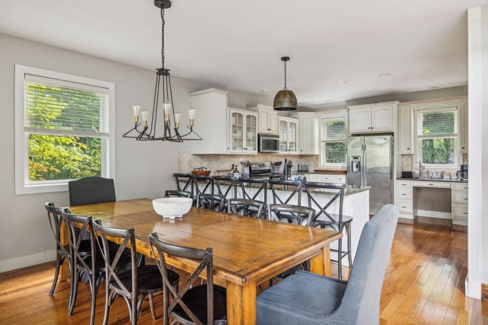 Spacious dining area with seating for eight and deck access.