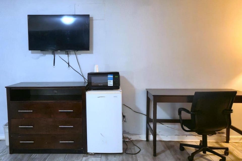 Kick back with TV, snacks, and an easy work desk.