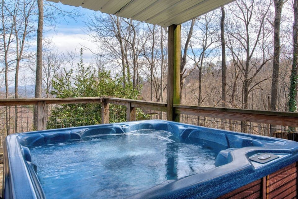 Soak in your private hot tub while enjoying forest views from this peaceful covered deck.