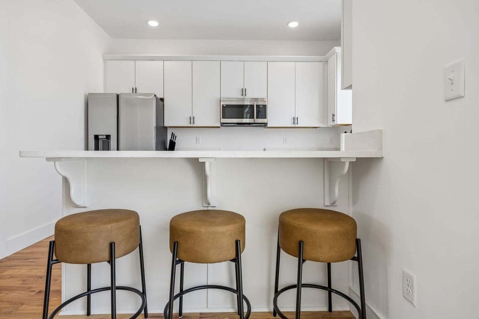 2nd Floor: Full kitchen with barstool seating at breakfast bar for additional dining seating