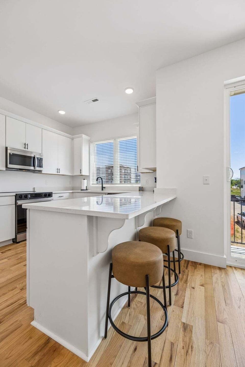2nd Floor: Full kitchen with barstool seating at breakfast bar for additional dining seating