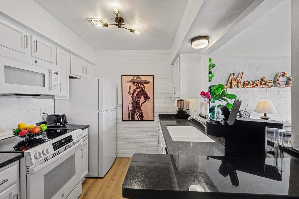 Fully equipped kitchen with stainless-steel appliances, ample counter space and bar seating for 2 guests.