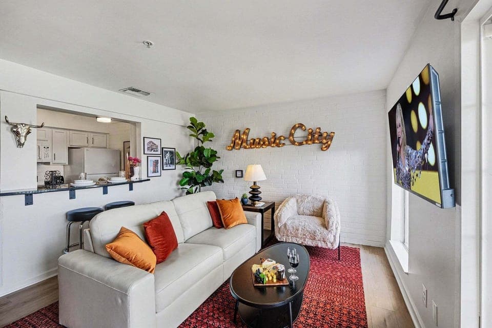 Open living area with Cozy furnishings, a smart TV, and access to the private patio overlooking the Cumberland River.