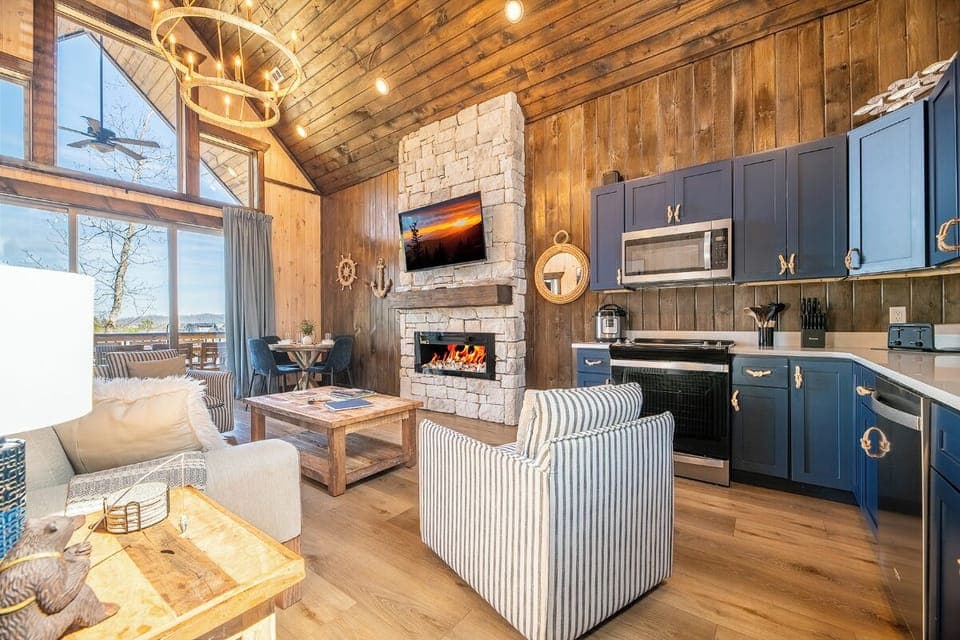 Cozy up in this stunning open-concept space where rustic wood meets modern comfort, featuring a crackling fireplace and fully equipped kitchen.