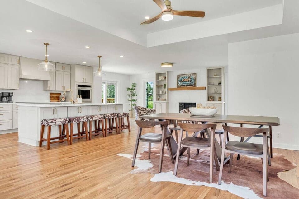 Elegant dining area featuring a table for six and six stools.