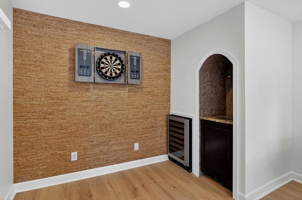 Challenge friends to darts in your entertainment room, complete with wine cooler for post-game refreshments.