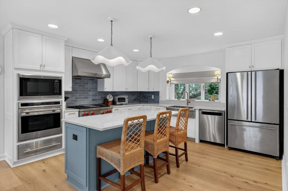 Your dream kitchen awaits with gleaming stainless appliances, marble counters, and a welcoming island perfect for morning coffee or evening meals.