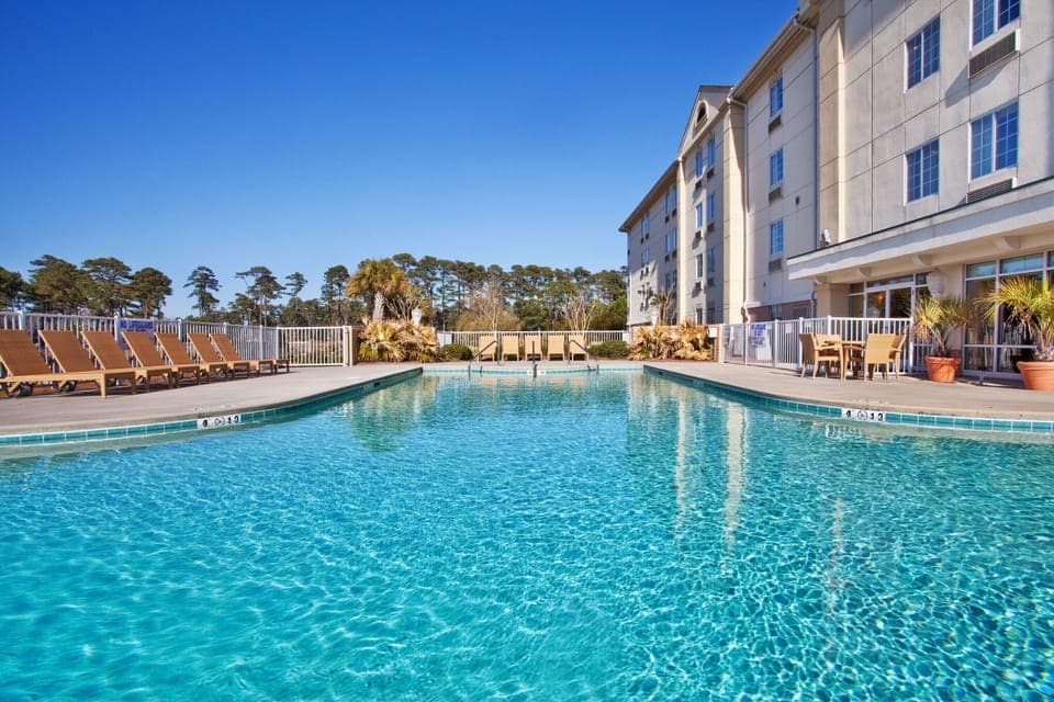 Dive into sparkling waters and soak up sunny poolside calm