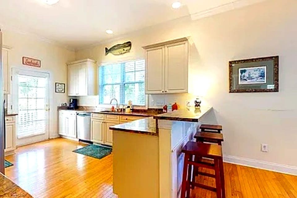 Fully equipped kitchen with granite counters, ample prep space and seating.