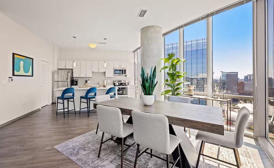 Settle into cozy conversation corners framed by dramatic city windows.