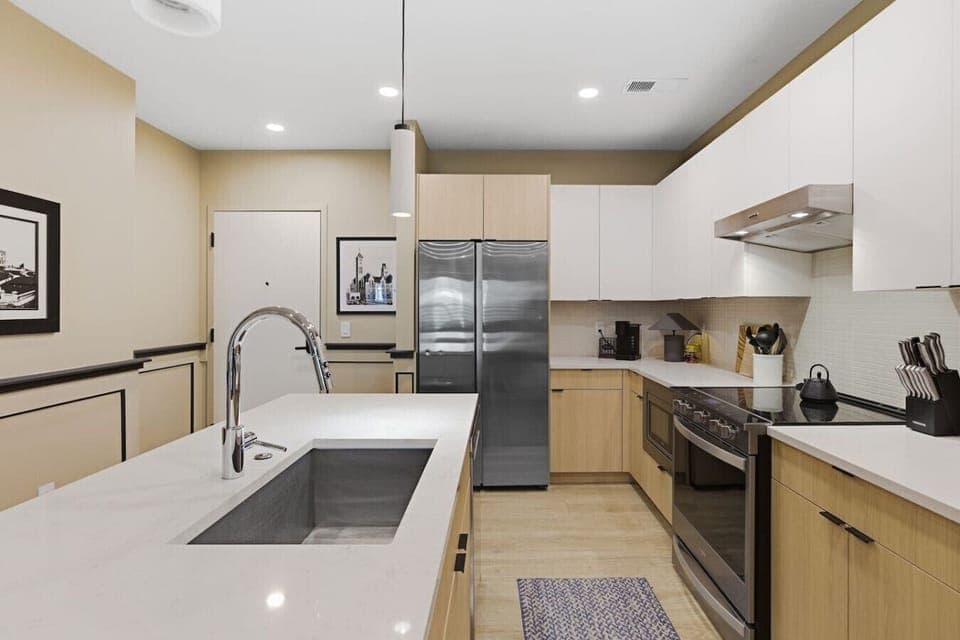 Fully equipped kitchen with modern appliances and ample counter space perfect for cooking a meal. Large island including seating for 4.