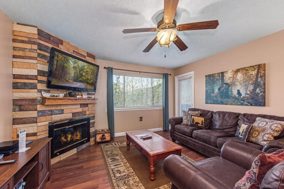 Cozy up on plush leather seating while enjoying your favorite shows and the warmth of the fireplace on peaceful evenings.