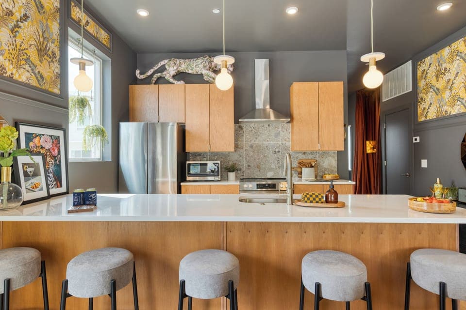 Unit 101: Sleek, modern kitchen with barstool seating.